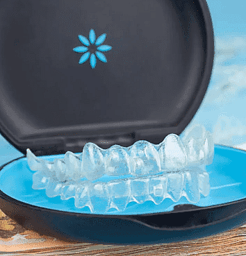 Inside a black and blue floral storage case, clear dental aligners illustrate the convenience and style of Invisalign Payment Plan options at Happy Smiles Orthodontics in St. Augustine, FL.