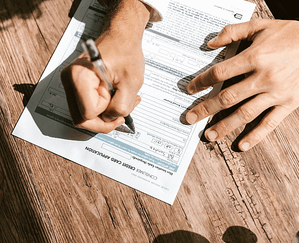 While completing a paper credit card application on a wooden table, someone considering treatment at Happy Smiles Orthodontics in St. Augustine, FL might wonder if Invisalign will be covered by insurance.