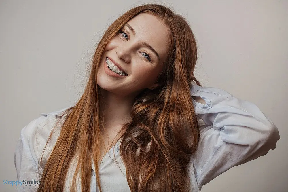 happy young red haired woman in clear braces smiling - Alternatives to Braces in St. Augustine, FL