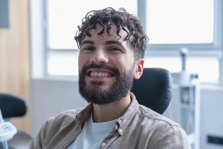 attractive smiling bearded man with clear braces - Clear Braces vs Metal Braces in St. Augustine, FL