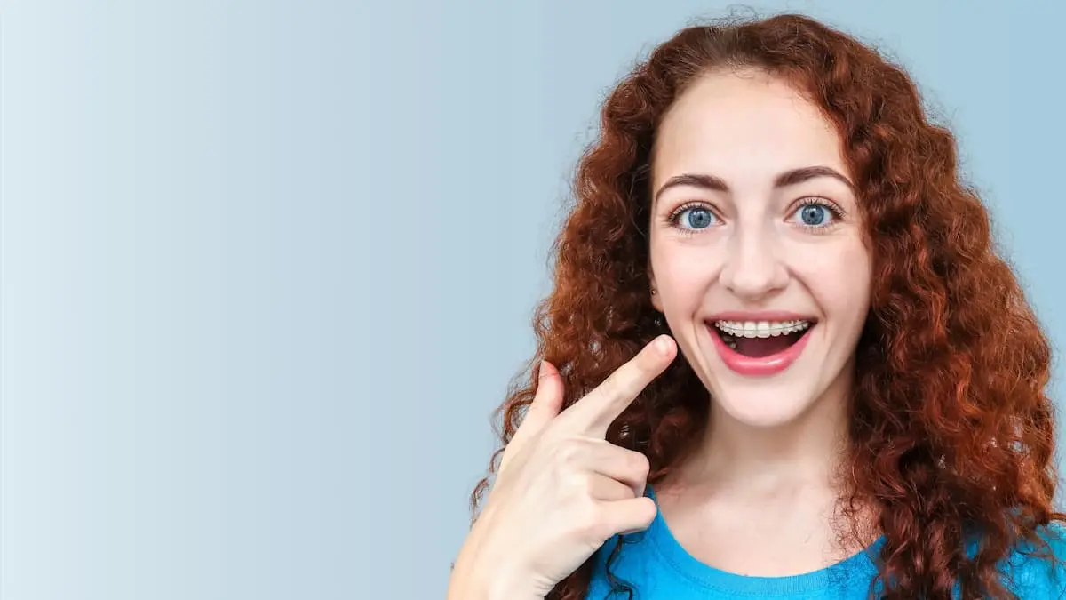 A women wearing an adult braces, smiling happily at Happy Smiles Orthodontics in St. Augustine FL.